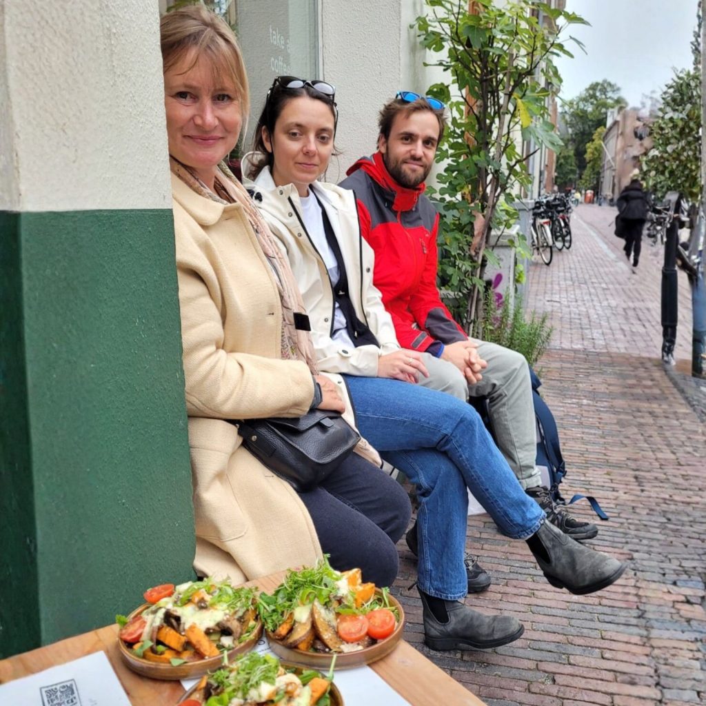 Plates of vegan food served outdoors at a café in Europe