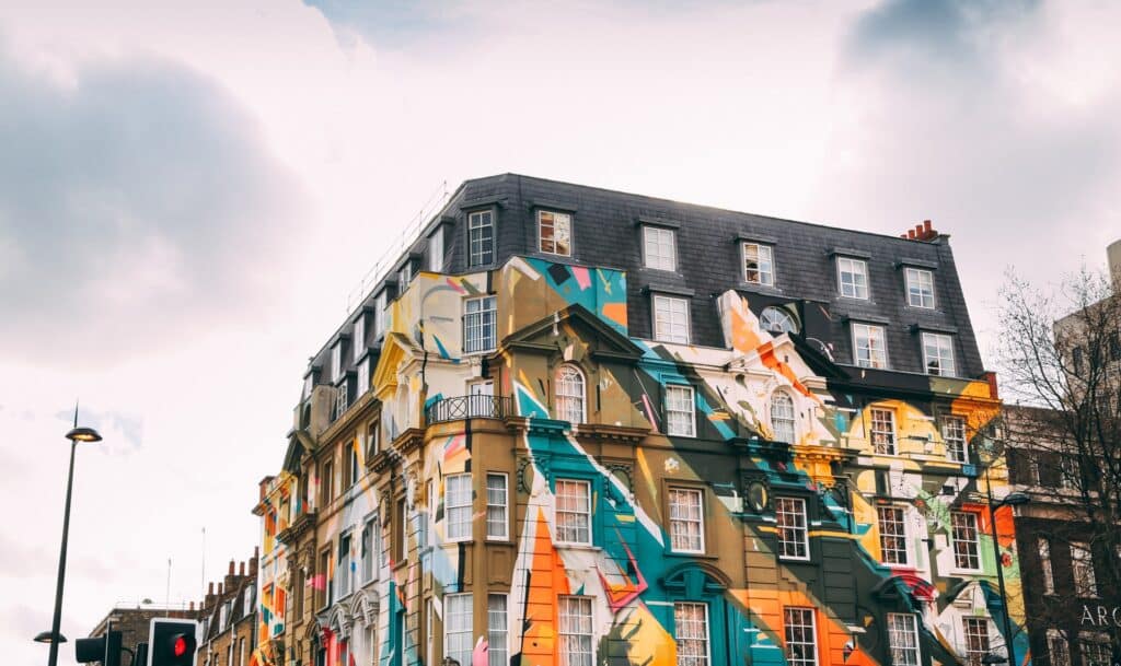 A picture of a london midsize london Georgian building with street art across the whole building.