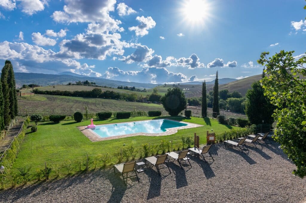 A sunny day overlooking a pool in Tuscany