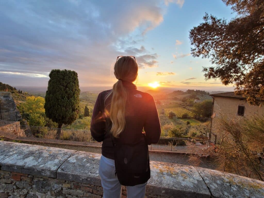 woman looking at the sunrise in Tuscany
