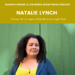 Women with curly hair in front of a green background with the test: The World Vegan Travel Podcast Season 4 episode 15, France, not as unvegan friendly as you might think Natalie Lynch