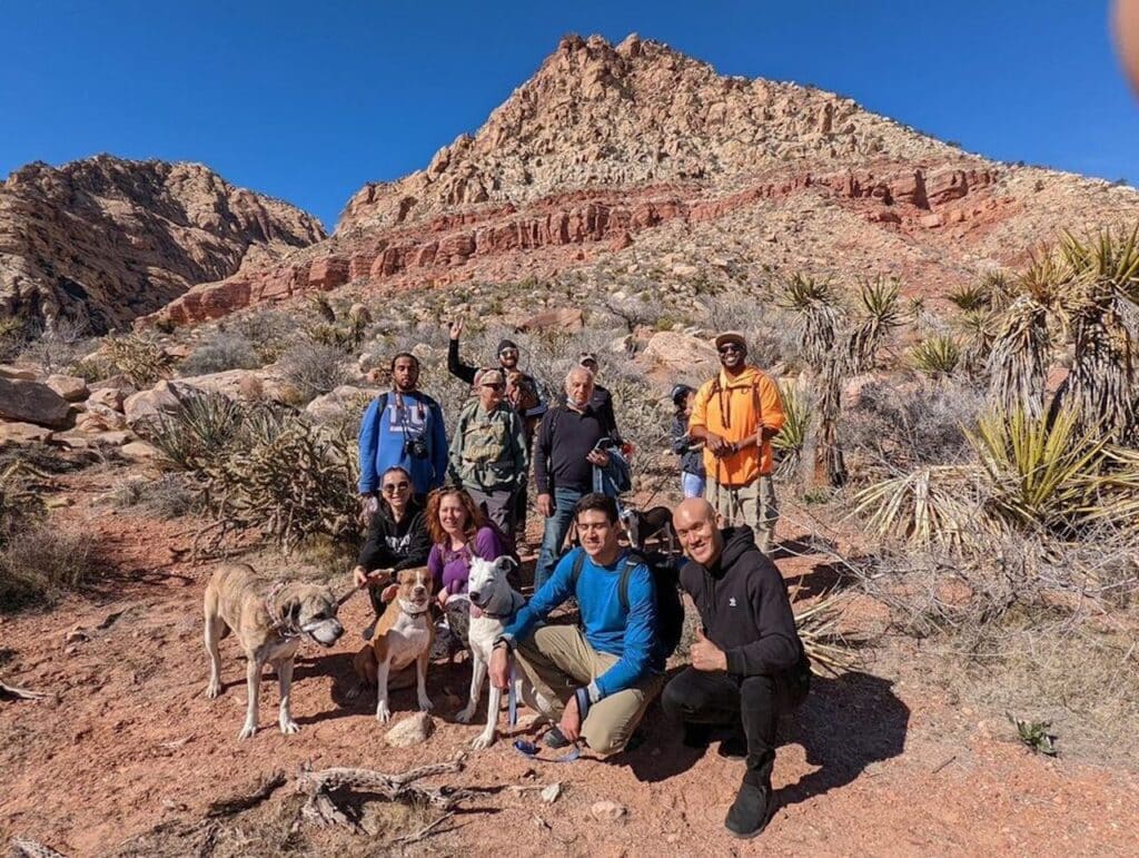 A hiking group with dogs in Las Vegas posing for a picture 
