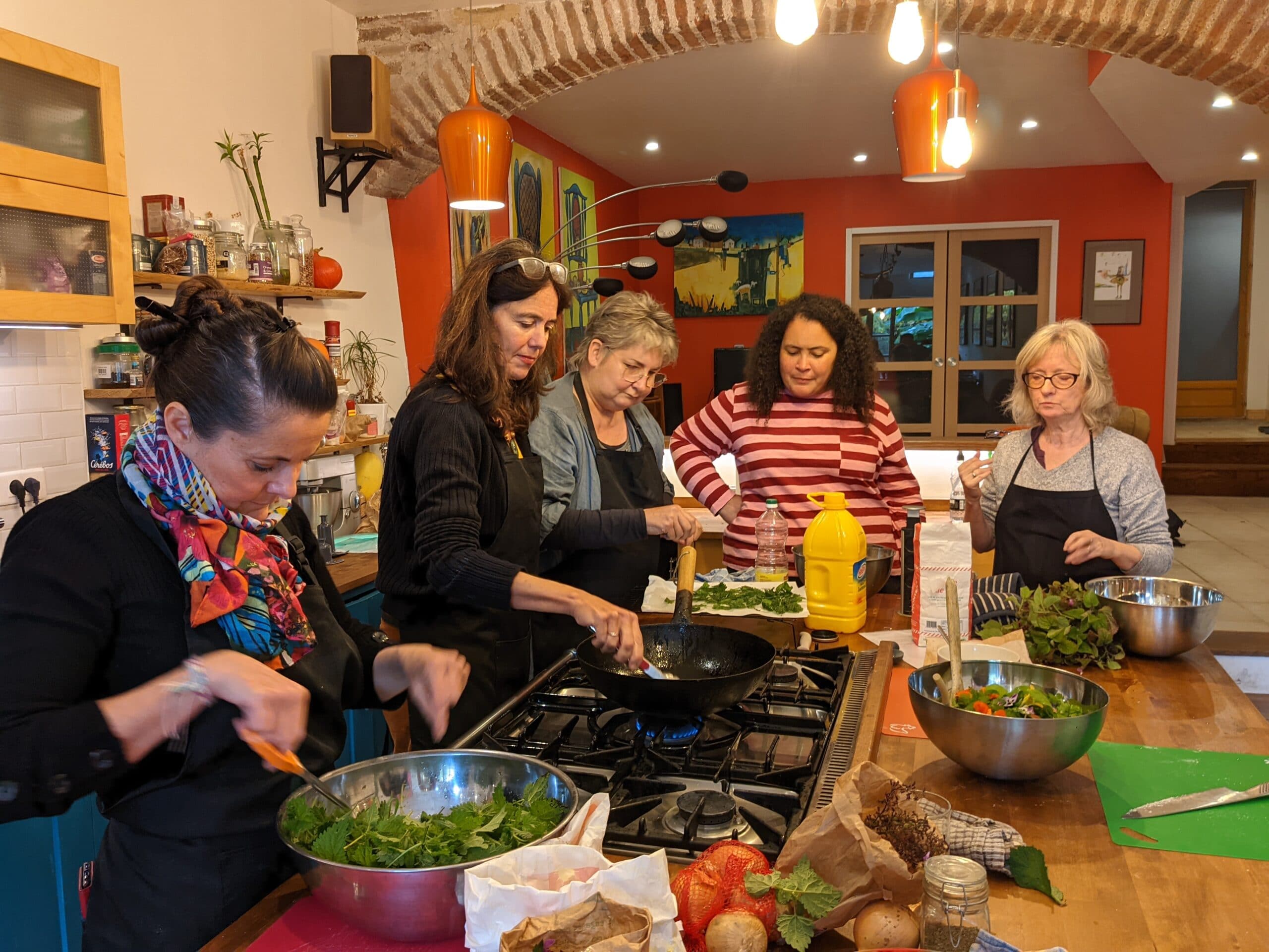 A group of people in a French country kitchen cooking together