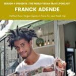 smiling head of a rasta guy holding a opened map in front of a vegan restaurant