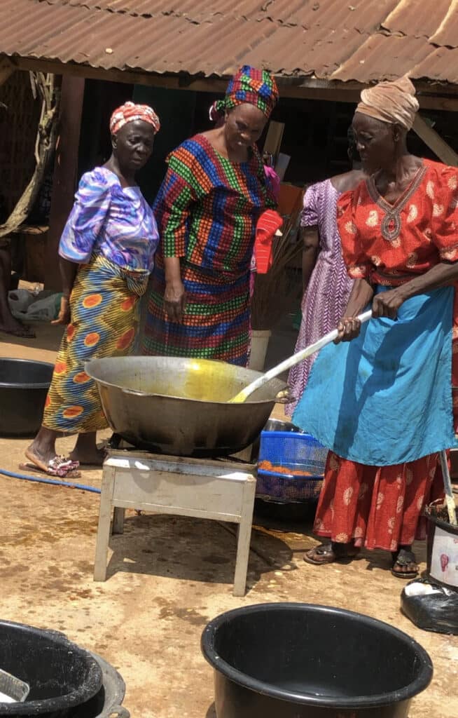 Nigerian women cooking outside
