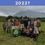 a group of people standing in front of a mountain with the text: Who were our travelers in 2022?