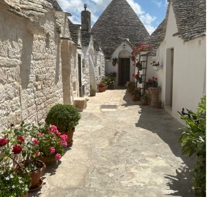 A sideview of cone shaped homes with whitewashed walls