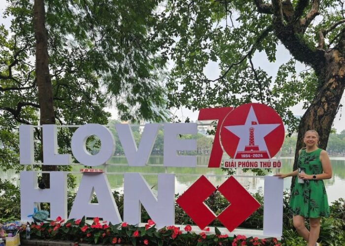 Cover page of blog: Hanoi for Vegans, featuring I love Hanoi Sign with Brighde Founder of World Vegan Travel