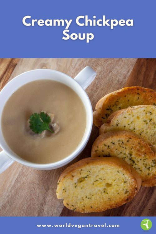 Bowl of creamy chickpea soup served with slices of toasted vegan garlic bread