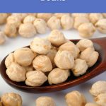 Crunchy garbanzo beans piled on a wooden spoon ready for snacking