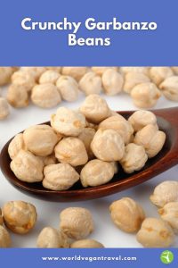 Crunchy garbanzo beans piled on a wooden spoon ready for snacking