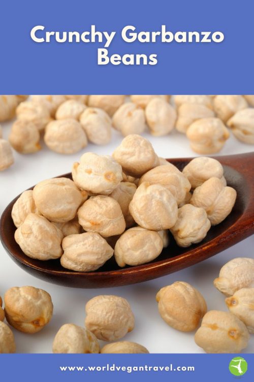 Crunchy garbanzo beans piled on a wooden spoon ready for snacking
