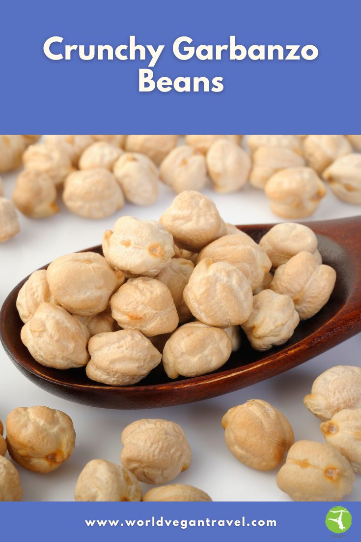 Crunchy garbanzo beans piled on a wooden spoon ready for snacking