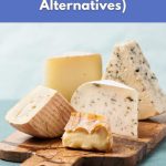 Different types of cheese on a wooden board to show why giving up cheese is hard and how vegan alternatives can help.