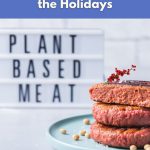 Stack of vegan plant-based burgers on a plate with a festive garnish.