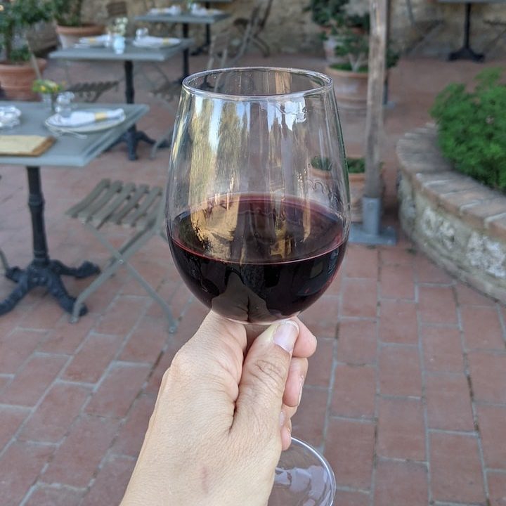 World Vegan Travel a glass of wine with a patio on the background