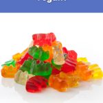 A heap of colorful gummy bears on a white surface