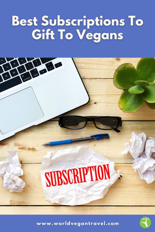 A laptop, plant, glasses, and a crumpled paper labeled “subscription,” showing the idea of choosing the best subscriptions to gift to vegans.