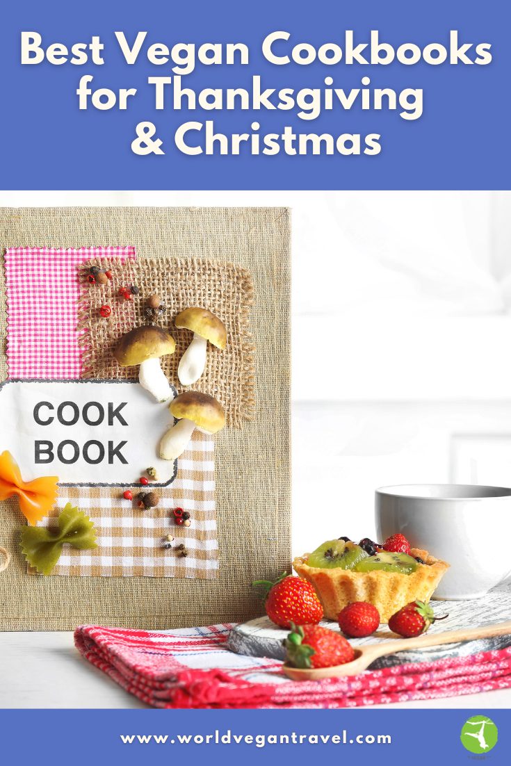 Vegan cookbook surrounded by fresh fruit, a tart, and a cup of coffee — the perfect inspiration for Thanksgiving and Christmas cooking.