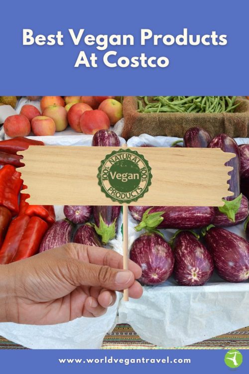 Hand holding a “Vegan Products” sign over fresh vegetables and fruit with the text “Best Vegan Products at Costco.”