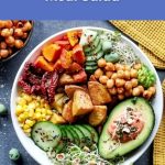 Colorful vegan salad bowl filled with veggies, potatoes, avocado and chickpeas, representing a healthy main-meal salad idea by World Vegan Travel.
