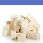 Cubes of white feta-style cheese stacked on a clean white background.