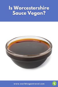 A small glass bowl filled with dark Worcestershire-style sauce on a white background, used for the World Vegan Travel blog post about vegan Worcestershire sauce.
