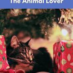 Vegan Etsy holiday gifts for animal lovers – cat resting by Christmas tree with presents.