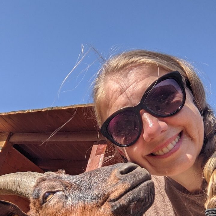 World Vegan Travel A woman with a goat