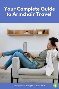 A woman relaxing in an armchair while exploring travel ideas on her laptop, showing how armchair travel lets you explore the world from home.