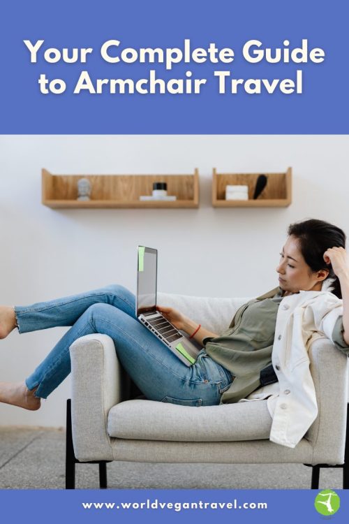 A woman relaxing in an armchair while exploring travel ideas on her laptop, showing how armchair travel lets you explore the world from home.
