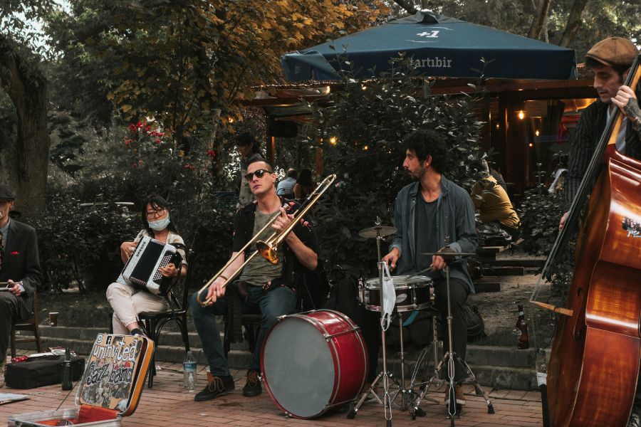 A group of street musicians playing instruments outdoors.