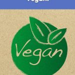 Green vegan logo with leaves and the text "21 Reasons to Go Vegan" on a natural paper background.