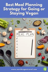 Clipboard with a meal plan surrounded by fresh vegetables and ingredients on a kitchen counter.