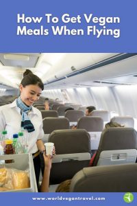 Flight attendant serving drinks on an airplane, showing what to expect when getting vegan meals when flying.