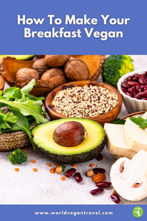 A colorful display of vegan breakfast ingredients including avocado, tofu, greens, mushrooms, quinoa, and nuts.