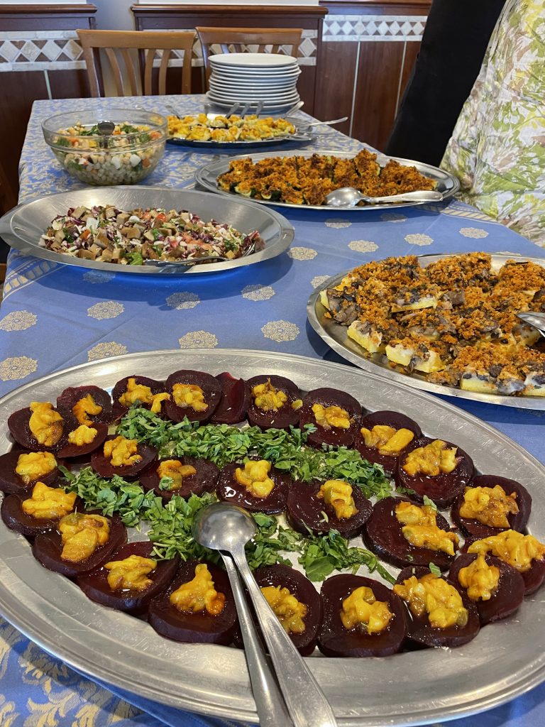 Assortment of vegan appetizers including beetroot, salad, and vegetables