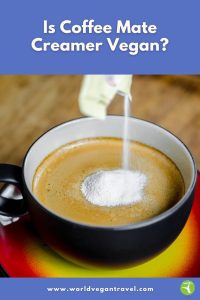 Powdered coffee creamer being poured into a hot cup of coffee