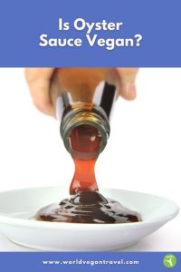 A bottle of dark oyster sauce being poured into a white dish, showing the thick glossy texture.