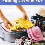 Person packing a yellow sweater into a suitcase with sneakers, camera, and travel essentials — World Vegan Travel carry on packing list.