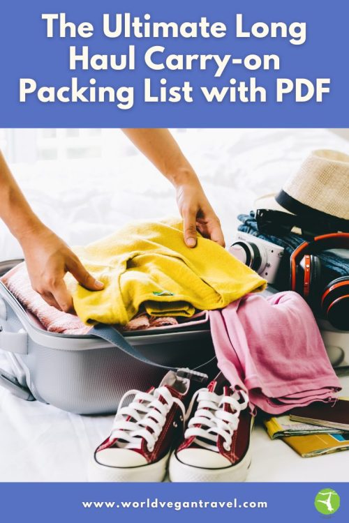 Person packing a yellow sweater into a suitcase with sneakers, camera, and travel essentials — World Vegan Travel carry on packing list.