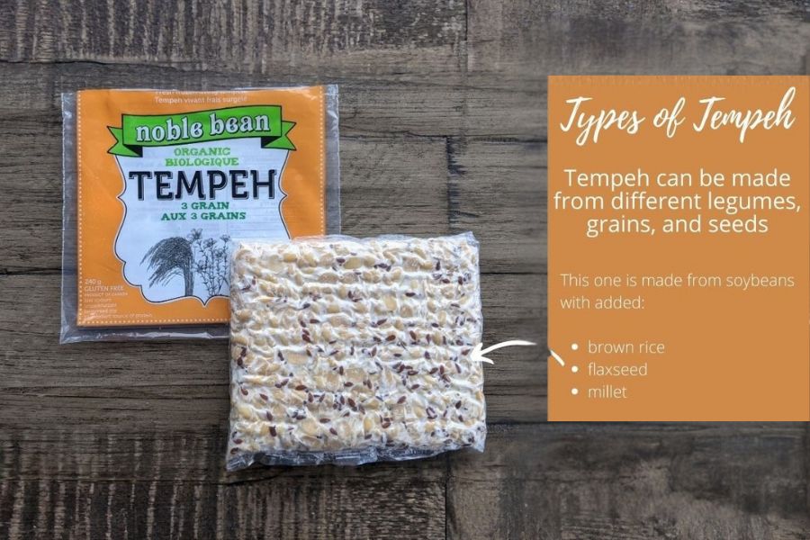 A block of tempeh next to packaging showing it’s made from soybeans, brown rice, flaxseed, and millet.