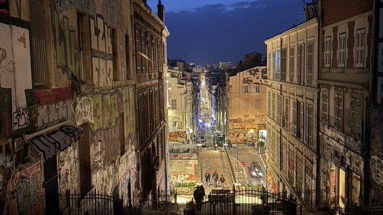 World Vegan Travel_Night view of a street in Provence with city lights in the distance