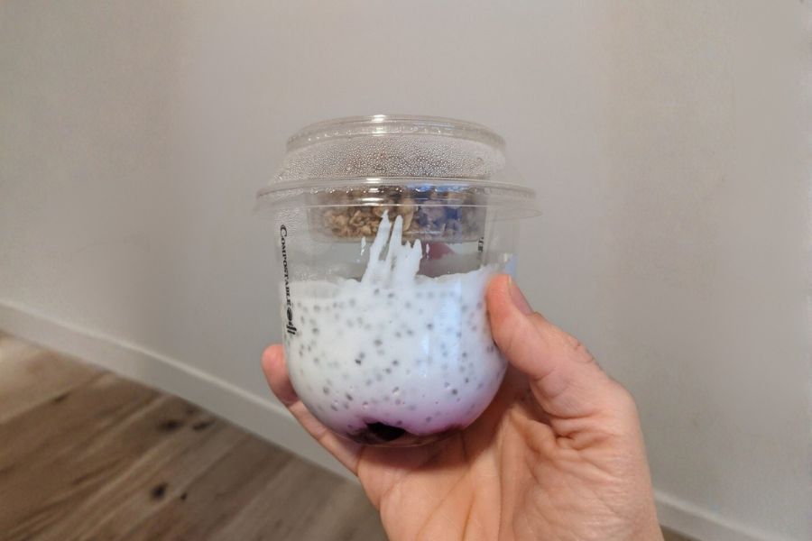 A cup of vegan coconut chia pudding topped with granola.