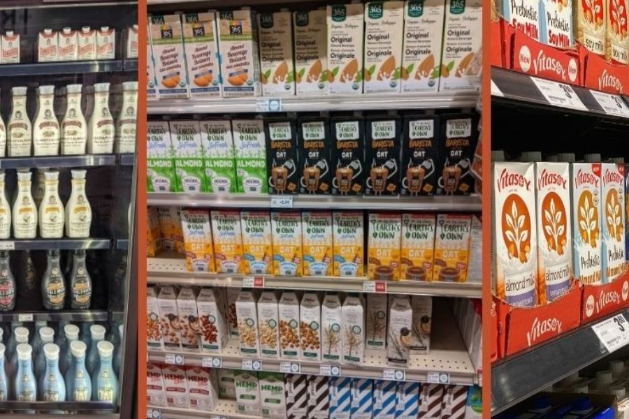 Shelves filled with oat, almond, soy, and other non-dairy milk cartons.