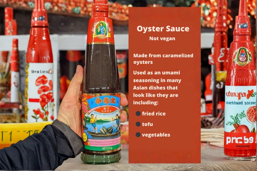 A bottle of traditional oyster sauce on a store shelf with a label explaining that oyster sauce is not vegan and is made from caramelized oysters.