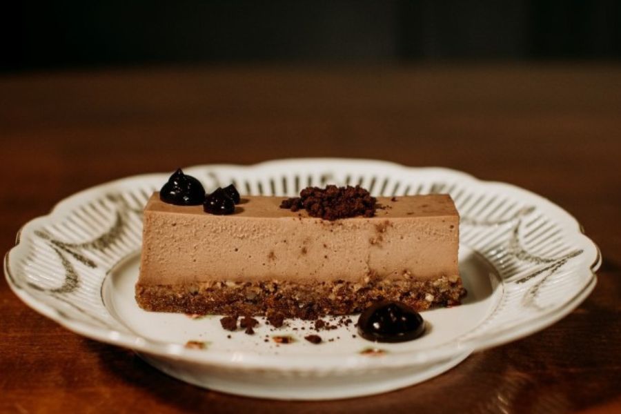 Vegan chocolate cheesecake slice on a plate at The Raven Room in Whistler.
