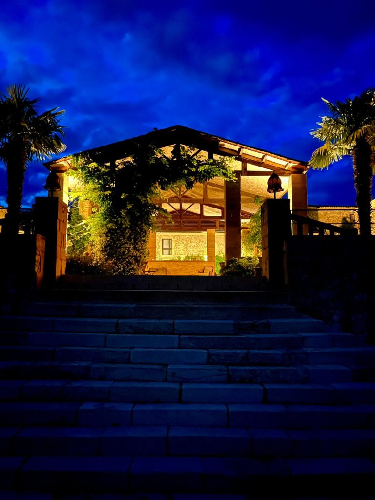 Cozy French villa glowing warmly under a deep blue night sky