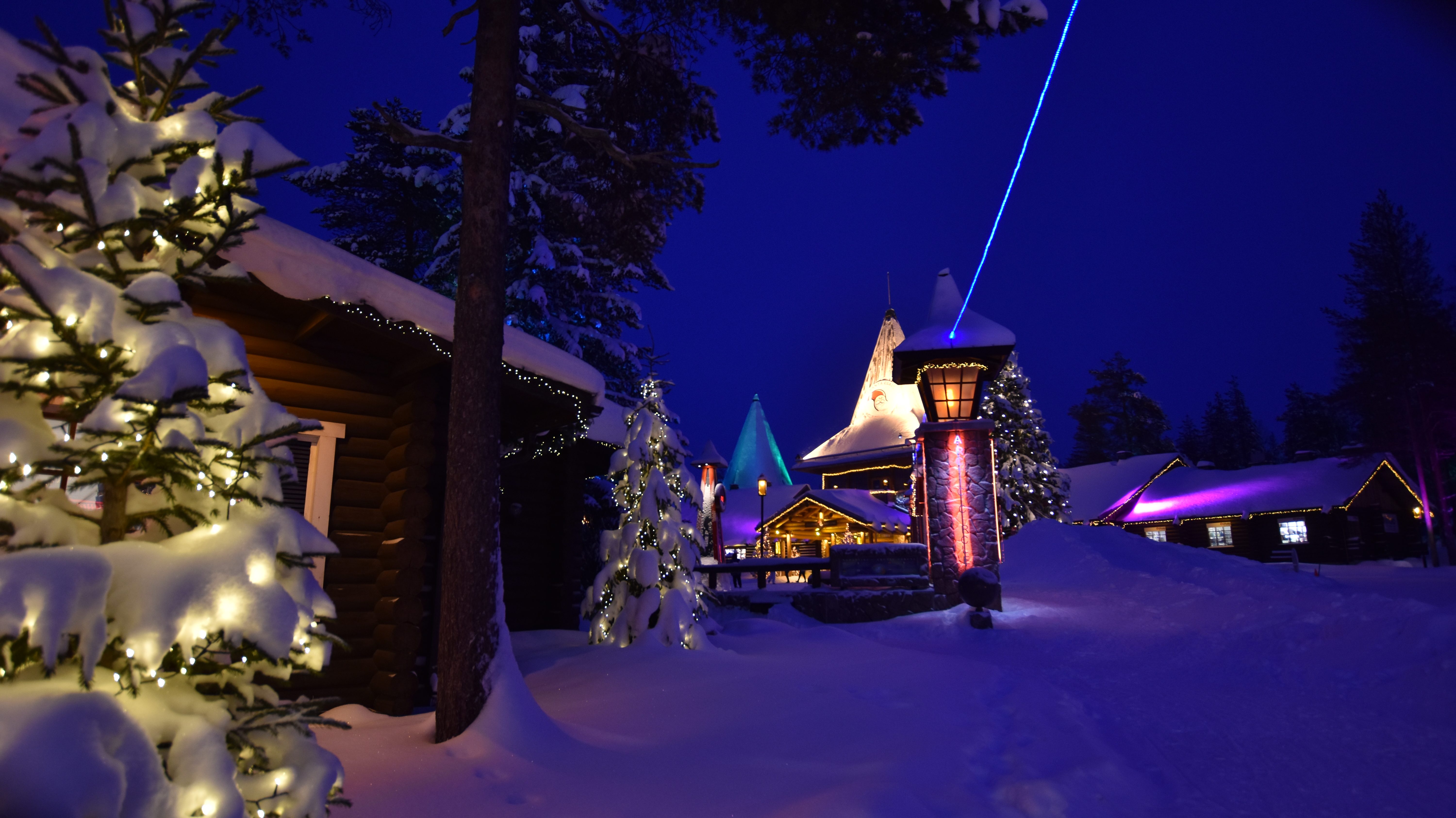 A traveler enjoys stand-up paddleboarding on a quiet Finnish lake surrounded by forests.
