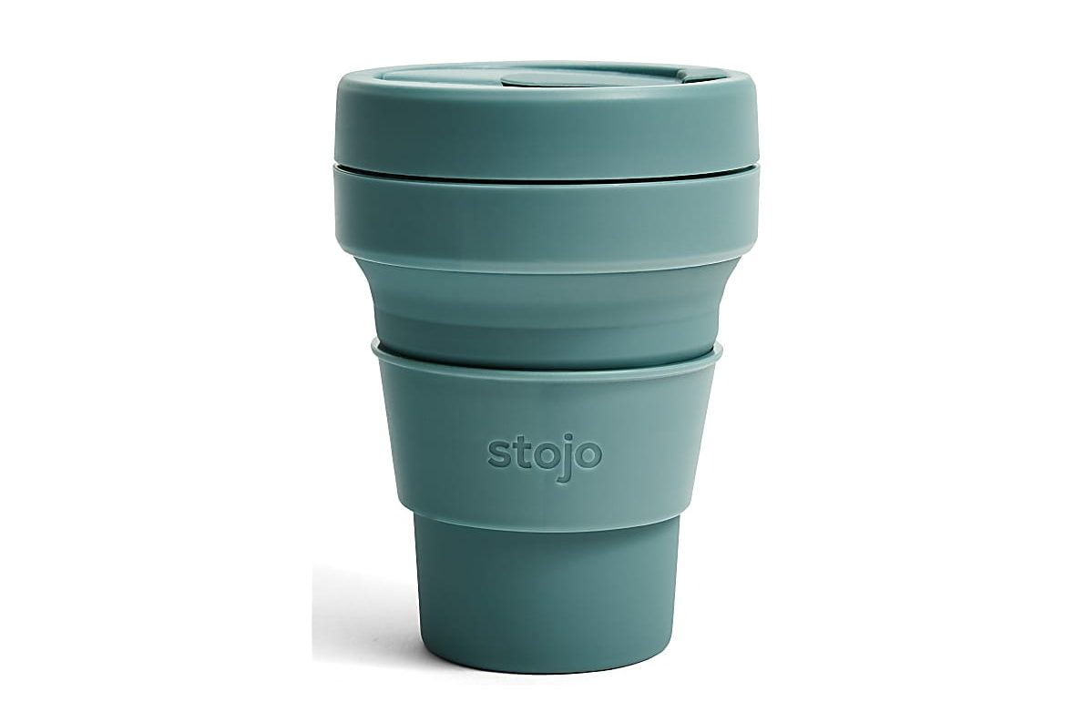 Stojo collapsible pocket cup — compressed and expanded travel cup in eucalyptus colour